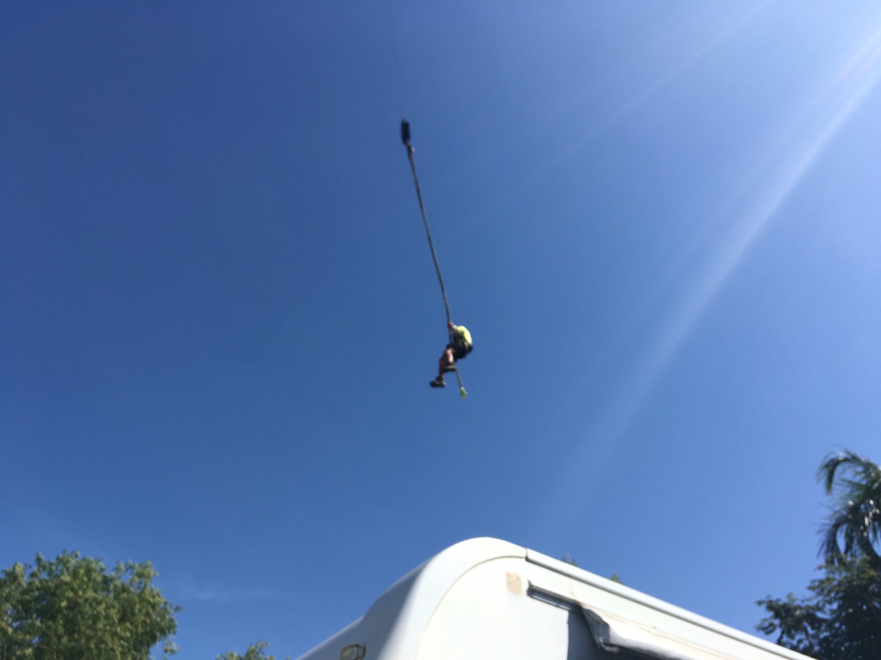 You lift the guy into the tree to tie a chain 